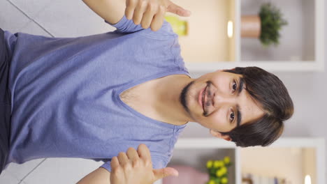Vertical-video-of-Man-making-positive-gesture-at-camera.